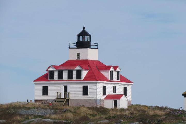 a small clock tower in front of a house