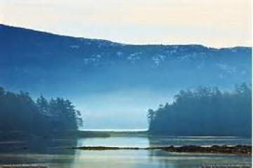 a body of water with a mountain in the background