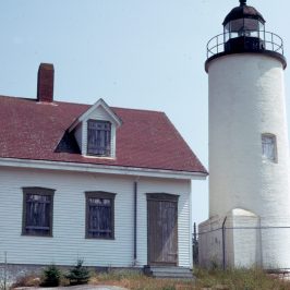 a small clock tower in front of a house
