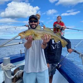 a man holding a fish