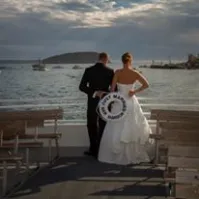 a person standing next to a body of water